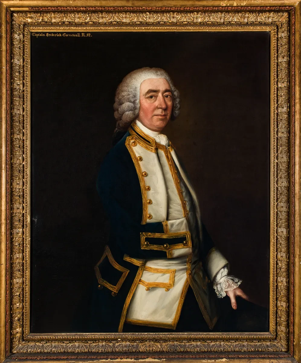 A portrait of a naval officer from the 1700s. He is wearing navy blue jacket with gold detailing and a curly wig. He is positioned slightly side on in the portrait but looking directly at the viewer. The painting includes an ornate gold frame